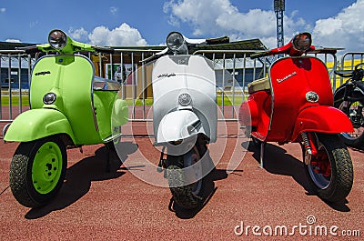 Heraklion, Crete / Greece - Jul 6, 2013: Three vintage italian designed Vespa scooters in green, white, red color that representin Editorial Stock Photo