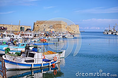 Heraklion, Crete - Greece. Traditional fishing boats in front of the fortress Koules castello a mare at the old port in Heraklio Stock Photo