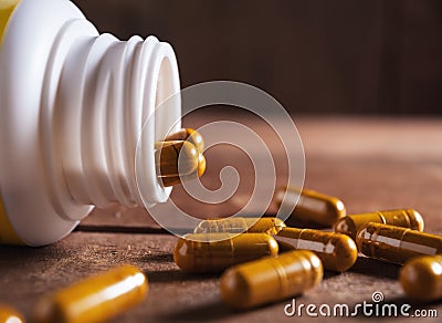 Herb capsule spilling out of a bottle still life tone Stock Photo