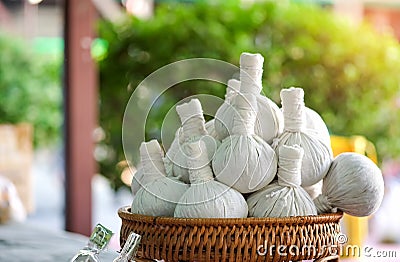 Herbal compress on wood basket in the market. Stock Photo