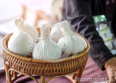 Herbal compress on wood basket in the market. Stock Photo