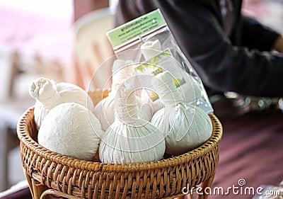 Herbal compress on wood basket in the market. Stock Photo