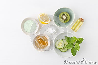 Herbal dermatology cosmetic hygienic cream for beauty and skincare product. honey, lemon, kiwi, cucumber, salt, mint, oil on whit Stock Photo