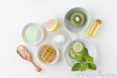 Herbal dermatology cosmetic hygienic cream for beauty and skincare product. honey, lemon, kiwi, cucumber, salt, mint, oil on whit Stock Photo