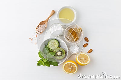 Herbal dermatology cosmetic hygienic cream for beauty and skincare product. honey, lemon, kiwi, cucumber, salt, mint, oil on whit Stock Photo