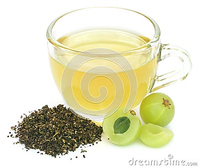 Herbal green tea in a cup with amla fruits Stock Photo