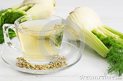 Herbal infusion fennel tea in glass cup or mug with dried fennel seeds and fennel bulbs Stock Photo