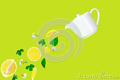 Herbal lemon tea pouring from white porcelain teapot on green surface. Lifestyle relax in autumn season. Tea time concept Stock Photo
