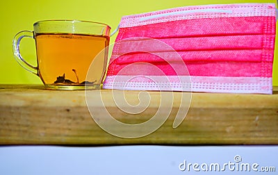 herbal and linden tea which protects against pandemic together with red medical mask. Stock Photo