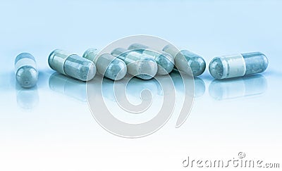 Herbal medicine in capsule pills on white background. Alternative medicine concept. Powder of herbal fill and pack in capsule. Stock Photo