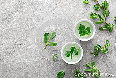 Herbal mint tea in small traditional chinese cups and fresh leaves Stock Photo