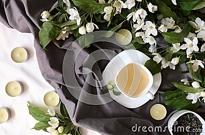 Herbal tea with flowers on gray textile, above view Stock Photo