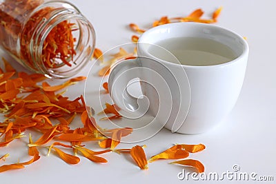 Herbal tea made from Calendula officinalus, or the Pot Marigold, with fresh orange flowers used as a colourant in Stock Photo