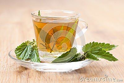 Herbal tea made of stinging nettle on wooden flooring Stock Photo