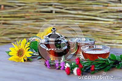 Herbal tea in teapot and cup. Stock Photo