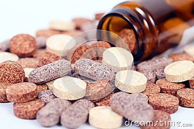 Closeup of herbal vitamin and supplement pills with herbs. Stock Photo