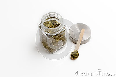 Herbs are in the glass jars with spoons. Stock Photo