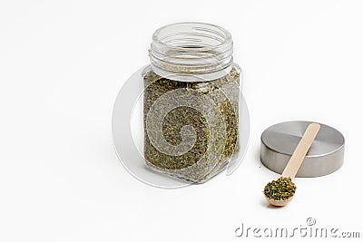 Herbs are in the glass jars with spoons. Stock Photo