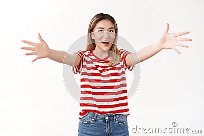 Here free hugs. Smiling optimistic cute friendly asian blond girl student welcoming best friend wanna embrace dear guest Stock Photo