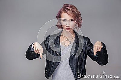 Here and right now. Portrait of bossy serious beautiful girl with short hair, makeup, casual style black leather jacket standing Stock Photo