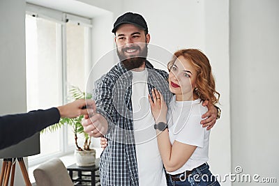 Here`s your keys. Happy couple together in their new house. Conception of moving Stock Photo