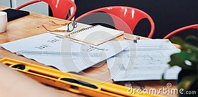 Here visions are turned into reality. Still life shot of a pair of spectacles placed on top an architects blueprints in Stock Photo