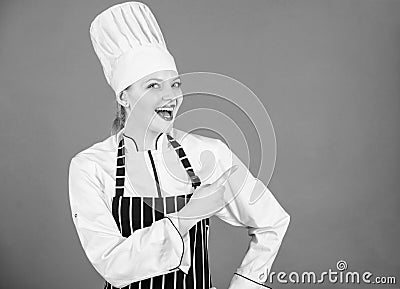 Here is your menu. Culinary expert advertising restaurant menu. Happy female cook pointing finger away and offering menu Stock Photo