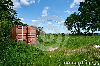 Herefordshire / UK - 6 June 2021: Mud coloured brown shipping container in Herefordshire field Editorial Stock Photo