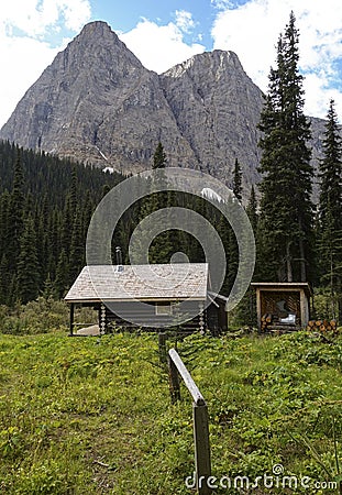 Outdoor Log Cabin Wooden Shack Horse Post Mountain Peak Canadian Rockies Summertime Stock Photo