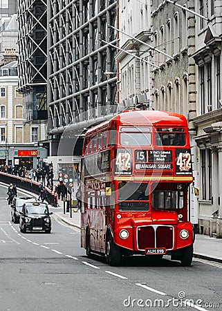 Heritage red Routemaster Bus operating in the City of London. Open platform at back facilitated speedy boarding under Editorial Stock Photo