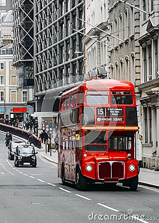 Heritage Routemaster Bus operating in a busy Central London street with traditional black cab on background Stock Photo