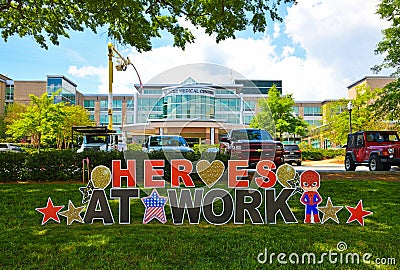 Heroes At Work Sign in Front of Medical Center Editorial Stock Photo