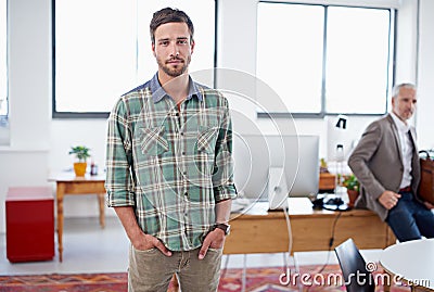 Hes ahead of the business curve. Portrait of a stylish young man standing in an office with a colleague in the Stock Photo