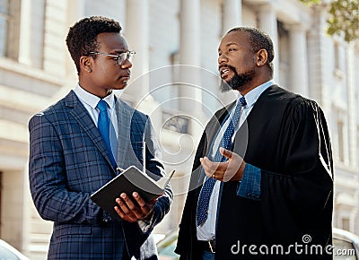 Hes got so much to learn. two lawyers talking in the city. Stock Photo