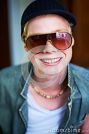 Hes not afraid to give you a smile. Young guy in urban clothing giving you a cheesy grin. Stock Photo