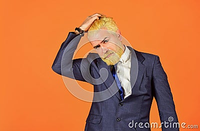 Hesitating businessman touch head. mature men dyed beard and hair. male grooming and personal hygiene. mens beauty Stock Photo