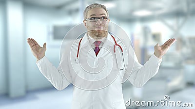 Hesitating doctor spreads his hands in the modern hospital Stock Photo