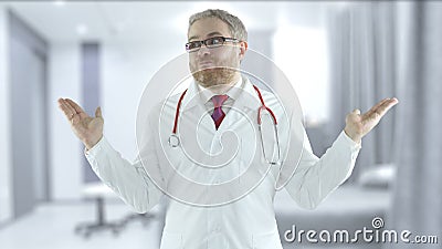 Incompetent doctor spreads his hands in a hospital ward Stock Photo