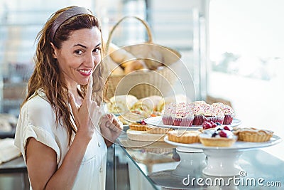 Hesitating pretty woman looking at camera Stock Photo