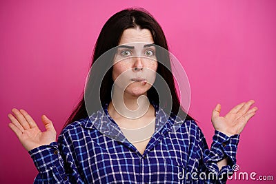 hesitating young woman lifting hands in dismay Stock Photo