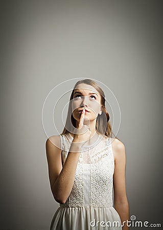 Hesitation. Young woman in white. Stock Photo