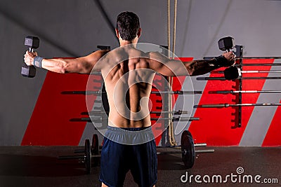Hex dumbbells man workout rear view at gym Stock Photo