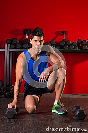 Hex dumbbells man workout in red gym Stock Photo