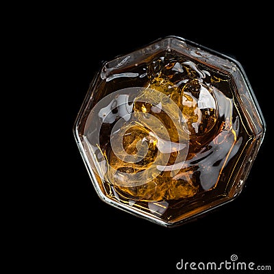 Hexagonal glass of whiskey with three cubes of real ice top view Stock Photo