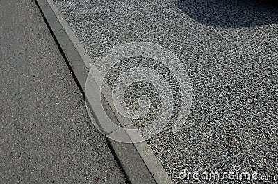 Hexagonal honeycomb tiles made of plastic and fiberglass fiber filled with gravel serve as a permeable surface that does not step Stock Photo