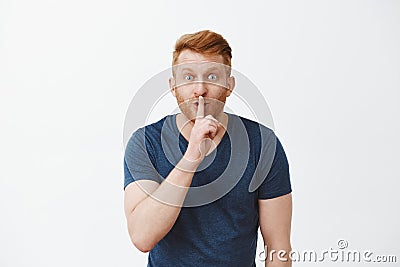 Hey, wanna hear my secret. Handsome enthusiastic redhead unshaven masculine male model being thrilled with great news Stock Photo