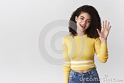 Hey what up. Friendly-looking outgoing attractive girl curly-haired wearing stylish cropped top tilting head say hi Stock Photo