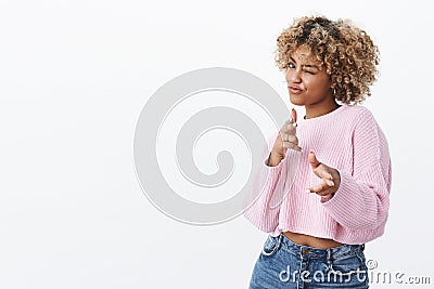 Hey you, bang. Joyful and charismatic good-looking emotive african woman with blond curly haircut winking and pointing Stock Photo