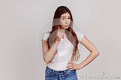 Hey you, be careful. Strict bossy woman seriously pointing finger and looking at camera, warning. Stock Photo