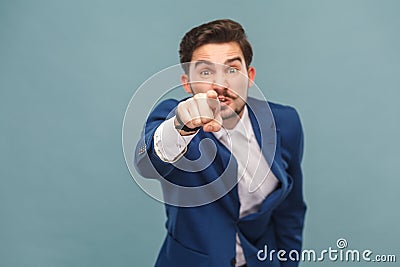 Hey you! Expressive man pointing finger at camera Stock Photo